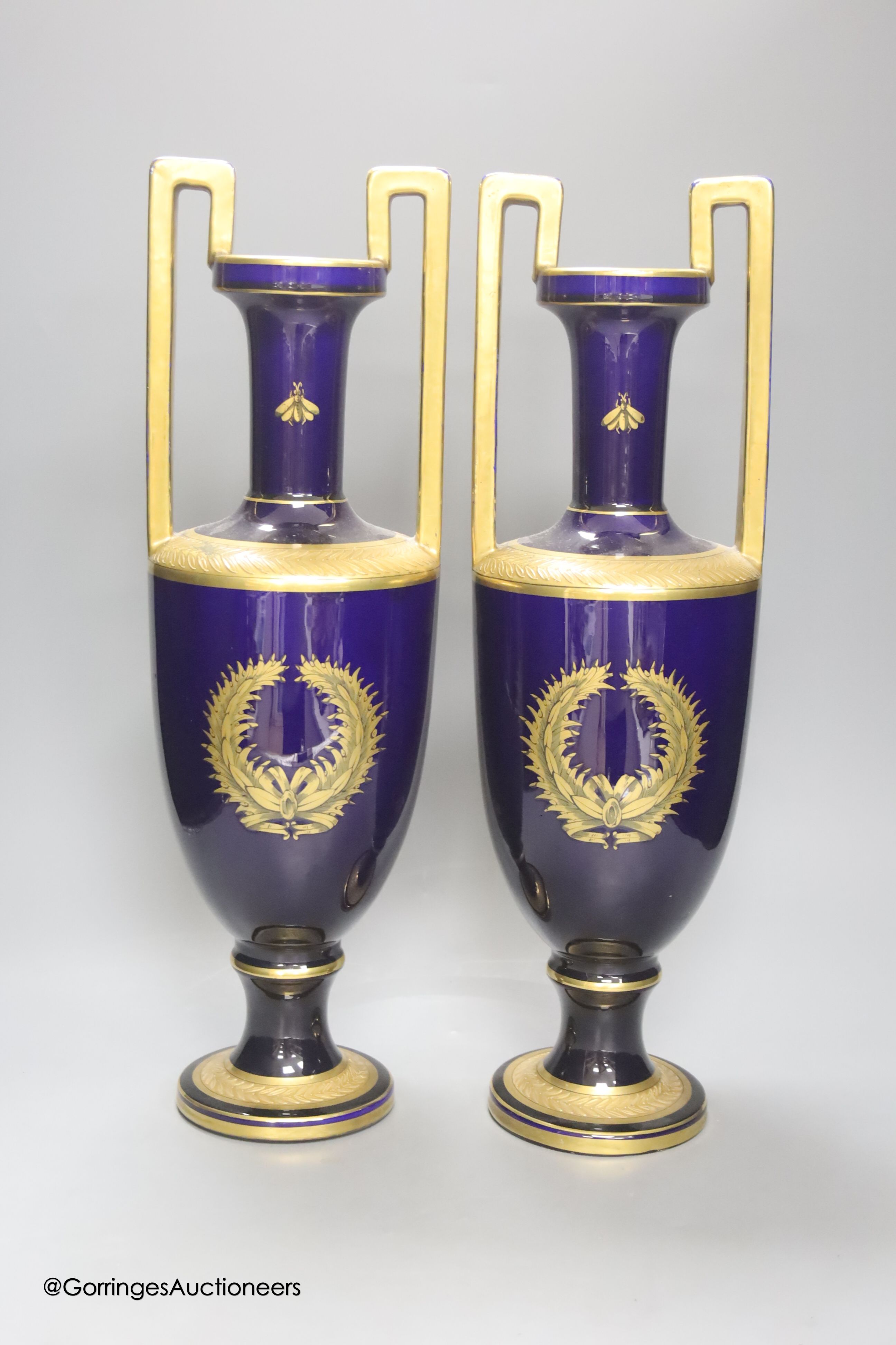 A pair of French gilt blue porcelain two handled vases, height 45cm
